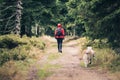 Happy woman hiking walking with dog Royalty Free Stock Photo