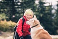 Happy woman hiking and walking with dog in autumn forest, friend Royalty Free Stock Photo