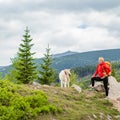 Happy woman hiking walking with dog in mountains, Poland Royalty Free Stock Photo