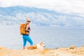 Happy woman hiking walking with dog on seaside trail Royalty Free Stock Photo