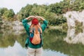 Woman in hat hiking in woods. Adventure women enjoying view of majestic mountain lake explore travel. Freedom and active Royalty Free Stock Photo