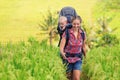 Happy woman hold child in backpack baby carrier Royalty Free Stock Photo