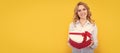 happy woman hold present heart box on yellow background. Woman isolated face portrait, banner with mock up copy space.