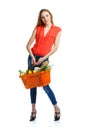 Happy woman holding a basket full of healthy food. Shopping Royalty Free Stock Photo