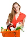 Happy woman holding a basket full of healthy food. Shopping Royalty Free Stock Photo