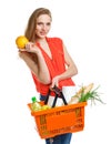 Happy woman holding a basket full of healthy food. Shopping Royalty Free Stock Photo