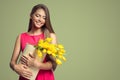 Happy woman holding basket with yellow tulips. Royalty Free Stock Photo
