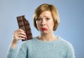 Happy woman holding big chocolate bar with mouth stains and crazy excited face expression Royalty Free Stock Photo