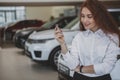 Happy woman holding car keys to her new automobile Royalty Free Stock Photo