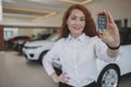 Happy woman holding car keys to her new automobile Royalty Free Stock Photo