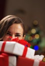 Happy woman holding christmas present boxes in front of face Royalty Free Stock Photo