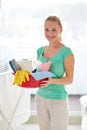 Happy woman holding cleaning stuff at home Royalty Free Stock Photo