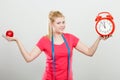 Happy woman holding clock, apple and measuring tape Royalty Free Stock Photo