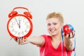 Happy woman holding clock, apple and measuring tape Royalty Free Stock Photo