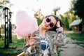 Happy woman holding a cotton candy, at the park Royalty Free Stock Photo