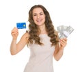 Happy woman holding credit card and dollars packs Royalty Free Stock Photo