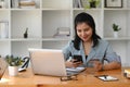 Woman holding credit card making banking online or shopping online on her smart phone. Royalty Free Stock Photo