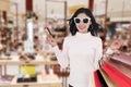 Woman holding credit card and shopping bag at mall Royalty Free Stock Photo