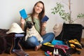 Happy woman holding dog passpoort ready for travel with pet. Girl packing of luggage for vacation with pug dog