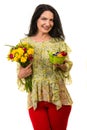 Happy woman holding flowers and basket with eggs Royalty Free Stock Photo