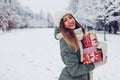 Happy woman holding heap of Christmas presents gift boxes in snowy winter park outdoors. Festive holiday season Royalty Free Stock Photo