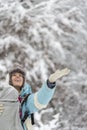 Happy woman holding her hand out to winter snow Royalty Free Stock Photo