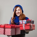 Happy woman holding many Christmas gifts