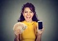 Happy woman holding mobile phone euro banknotes cash Royalty Free Stock Photo