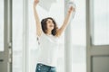 The happy woman holding papers near the window. Royalty Free Stock Photo