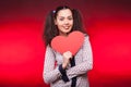 Happy woman holding a papper heart in hands