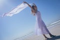 Happy woman holding scarf at beach Royalty Free Stock Photo