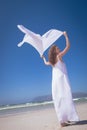 Happy woman holding scarf at beach Royalty Free Stock Photo