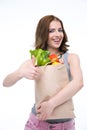 Happy woman holding a shopping bag full of groceries Royalty Free Stock Photo