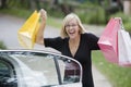 Happy woman holding shopping bags