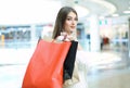 Happy woman holding shopping bags and smiling at the mall. Royalty Free Stock Photo