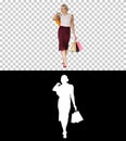 Happy woman holding shopping bags, smiling and walking, Alpha Channel Royalty Free Stock Photo