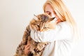 Happy woman holding siberian cat and kissing him Royalty Free Stock Photo