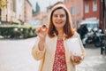 Happy woman holding Sicilian cannolo tube pastry filled with chocolate. Travel, Italy and holidays concept. Young women
