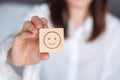 Happy Woman holding smile emotion face block. Customer choose Emoticon for user reviews. Service rating, mental health, positive Royalty Free Stock Photo