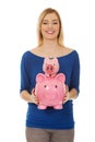 Happy woman holding two piggybanks.