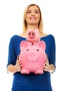 Happy woman holding two piggybanks.