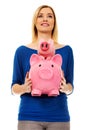 Happy woman holding two piggybanks.