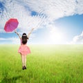 Happy Woman holding umbrella in green rice fields in sun sky Royalty Free Stock Photo