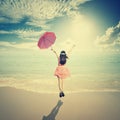 Happy Woman holding umbrella and Jumping in Sea sun sky Royalty Free Stock Photo