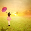 Happy Woman holding umbrella in rice fields and sunset Royalty Free Stock Photo