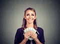 Happy woman holding US dollar bills looking up daydreaming how to spend Royalty Free Stock Photo