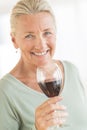 Happy Woman Holding Wineglass At Home