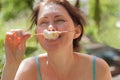 A happy woman holds a marshmallow stick Royalty Free Stock Photo