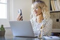 Happy woman at home doing phone call smiling in smart working indoor business activity alone. Cheerful corporate female people Royalty Free Stock Photo