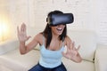 Happy woman at home living room sofa couch excited using 3d goggles watching 360 virtual reality